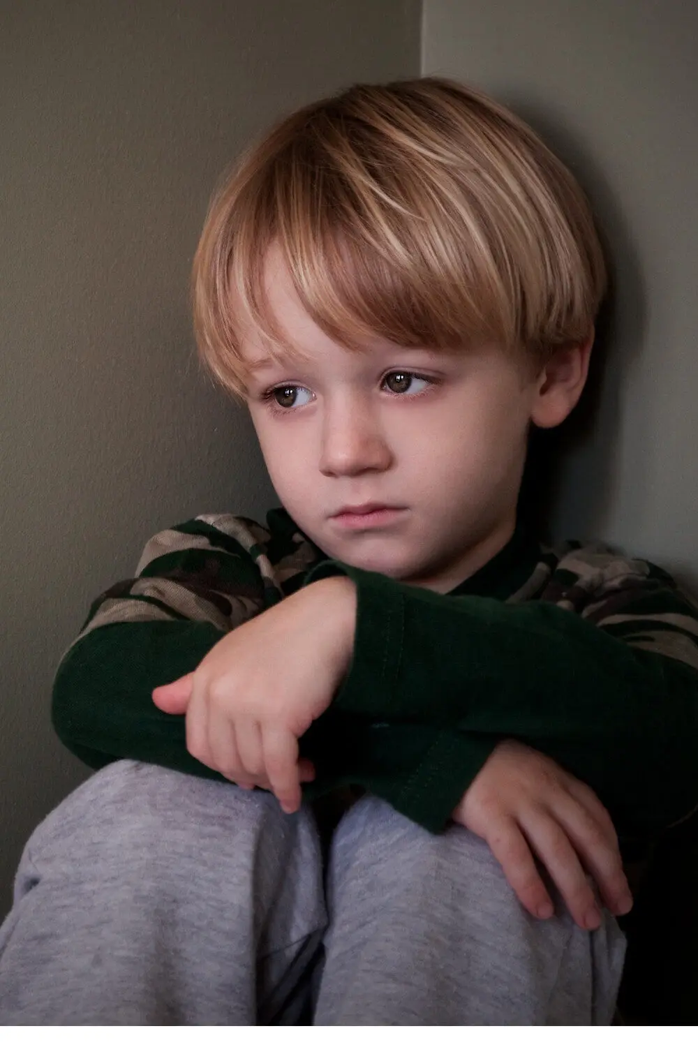 A dimly lit living room with a disheveled couch, piles of clutter, and an unattended toddler playing dangerously close to a power outlet. The parent, distracted by a smartphone, sits obliviously in the corner. The room is bathed in a harsh, fluorescent glow, casting shadows that emphasize the neglect and disconnect. The atmosphere is one of chaos, inattention, and a concerning lack of parental supervision, highlighting the complex issues of "bad parenting" behaviors. 2