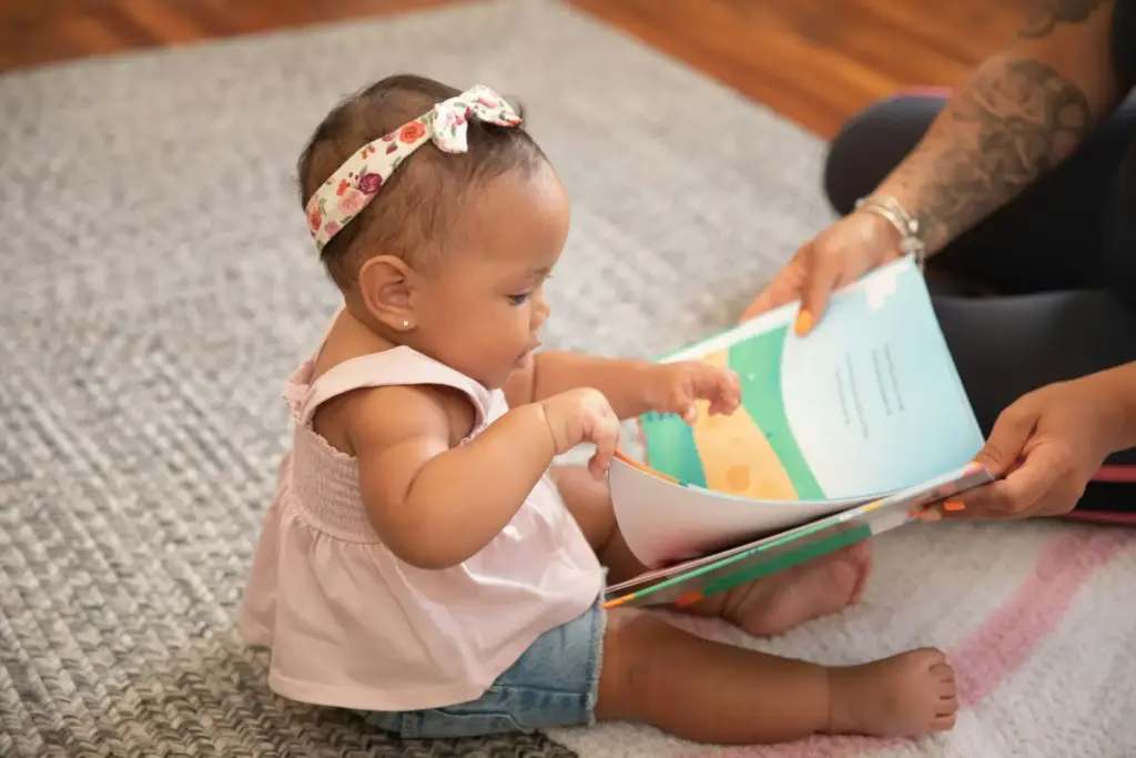 a baby reading a book a baby reading a book