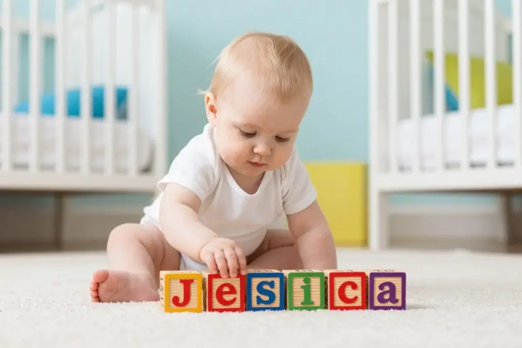 Baby girl named Jessica playing with toys