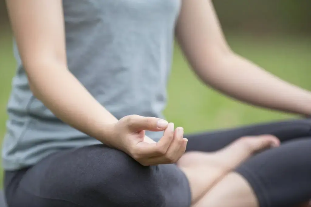 Person practicing mindful breathing outdoors