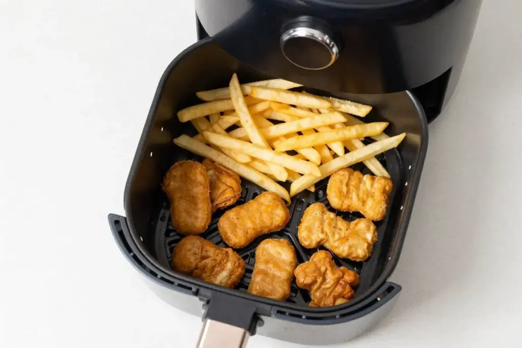 Frozen snacks arranged in an air fryer basket before cooking