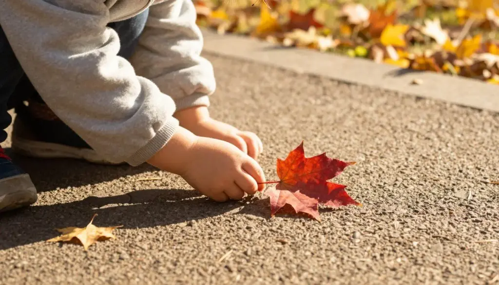 A child examining colourful leaves during 15 nature autumn activities for kids outdoors