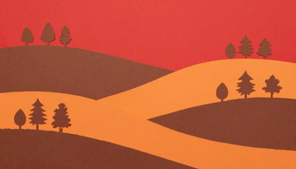 A layered autumn forest landscape made from torn colored construction paper