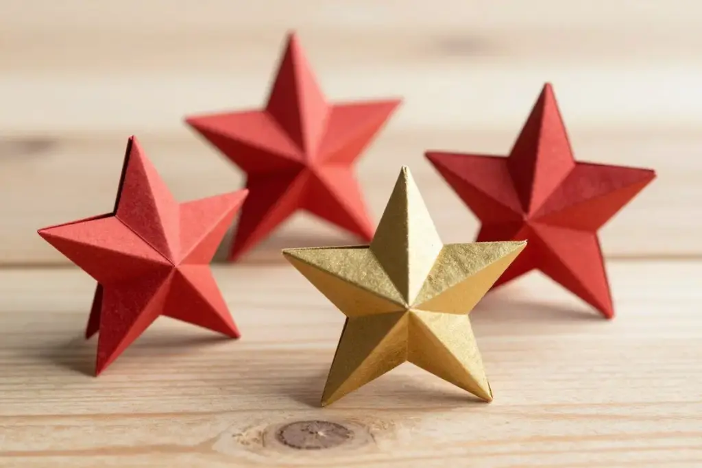 Folded colorful paper stars resting on a wooden tabletop