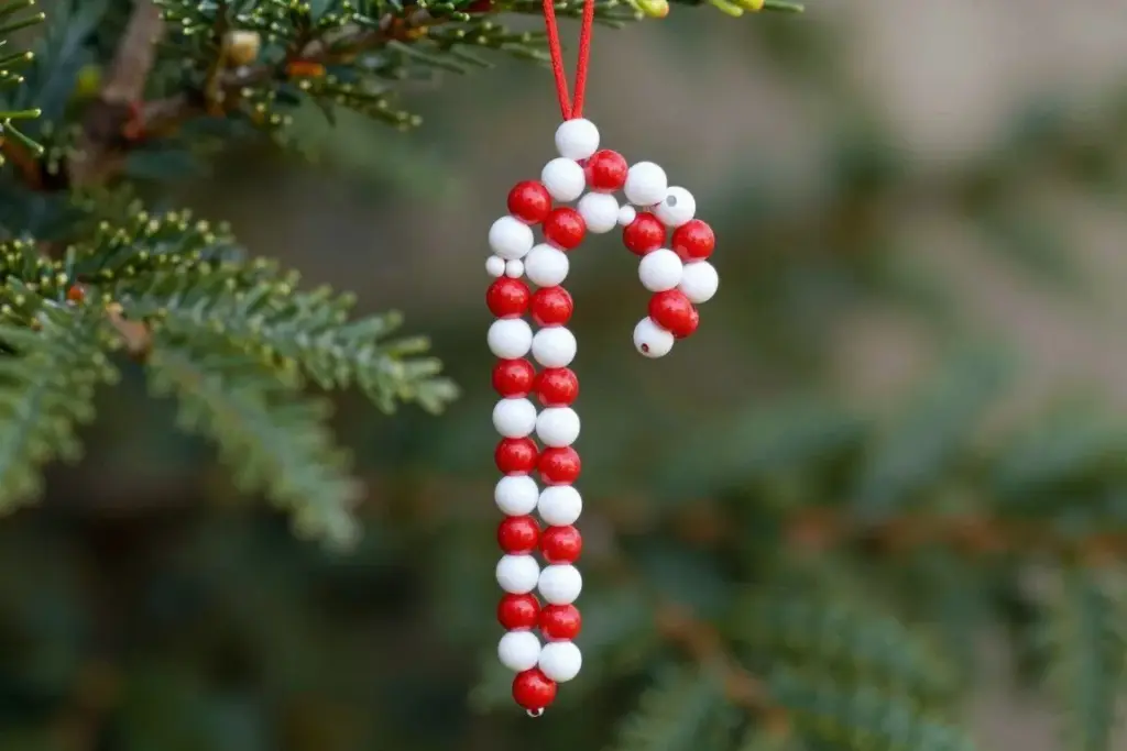 Handmade beaded candy cane ornament crafted from red and white beads