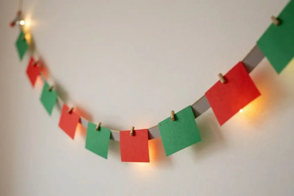 Red and green paper chain garland draped across a festive room