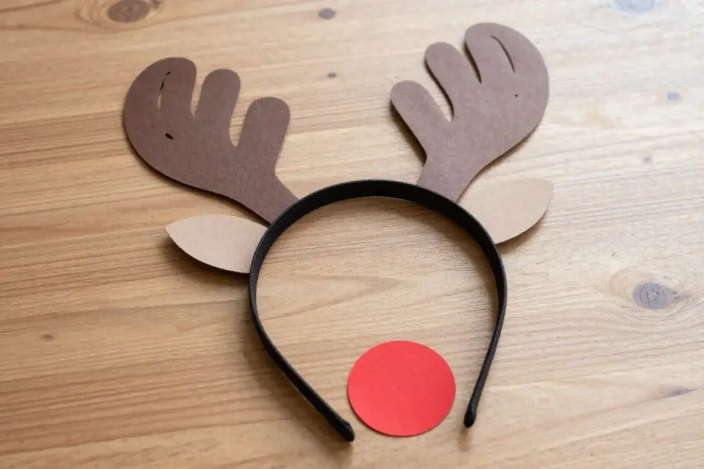 Reindeer paper headband with handprint antlers and red pom-pom nose